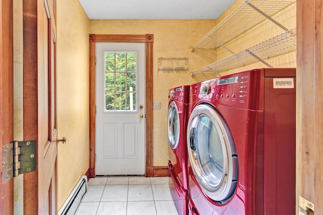 washroom featuring laundry area, separate washer and dryer, baseboard heating, light tile patterned flooring, and baseboards