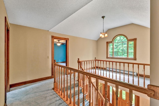 corridor featuring baseboards, an upstairs landing, carpet, vaulted ceiling, and a baseboard heating unit