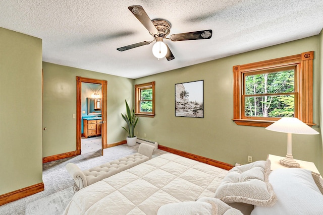bedroom featuring carpet, multiple windows, and a baseboard heating unit