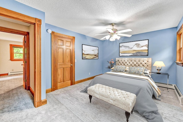 bedroom with a baseboard radiator, a ceiling fan, carpet, and baseboards