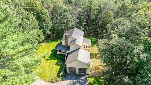 birds eye view of property featuring a view of trees