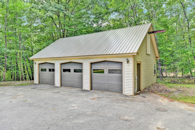 detached garage featuring a wooded view