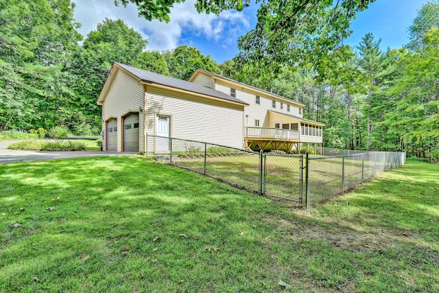view of home's exterior featuring aphalt driveway, fence, and a lawn