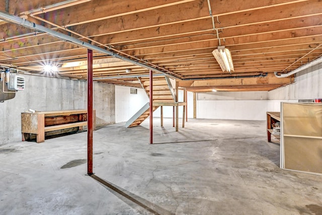 unfinished basement featuring stairway