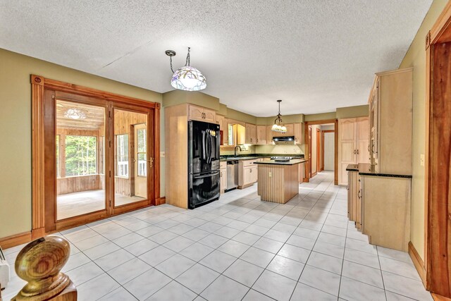 kitchen featuring freestanding refrigerator, a kitchen island, dark countertops, dishwasher, and a sink