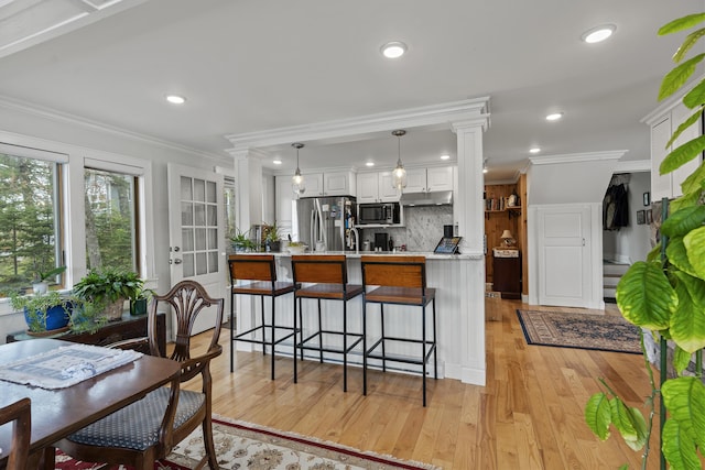 35 Barrows Rd, Boothbay Harbor, ME 04538 - kitchen with stainless steel appliances, light wood-style flooring, backsplash, white cabinetry, and light countertops