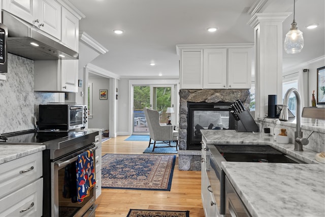 35 Barrows Rd, Boothbay Harbor, ME 04538 - kitchen with stainless steel electric range oven, decorative backsplash, light wood-type flooring, ornamental molding, and recessed lighting