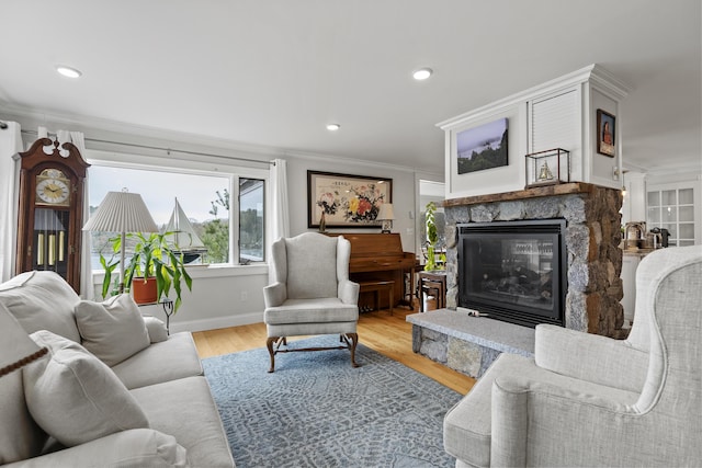 35 Barrows Rd, Boothbay Harbor, ME 04538 - living room featuring a stone fireplace, ornamental molding, light wood-style flooring, recessed lighting, and baseboards