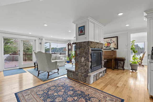 35 Barrows Rd, Boothbay Harbor, ME 04538 - living area featuring a stone fireplace, light wood-type flooring, ornamental molding, recessed lighting, and baseboards