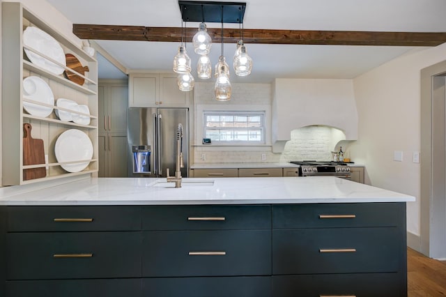 917 Main St, Fryeburg, ME 04037 - kitchen with stainless steel appliances, beamed ceiling, a sink, wood finished floors, and light stone countertops