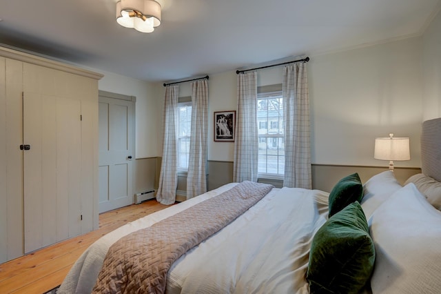 917 Main St, Fryeburg, ME 04037 - bedroom with a baseboard heating unit and wood finished floors