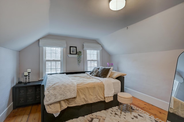 917 Main St, Fryeburg, ME 04037 - bedroom with hardwood / wood-style flooring, baseboards, and vaulted ceiling