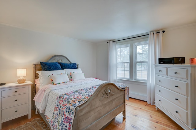 917 Main St, Fryeburg, ME 04037 - bedroom with a baseboard radiator, light wood-style flooring, and crown molding