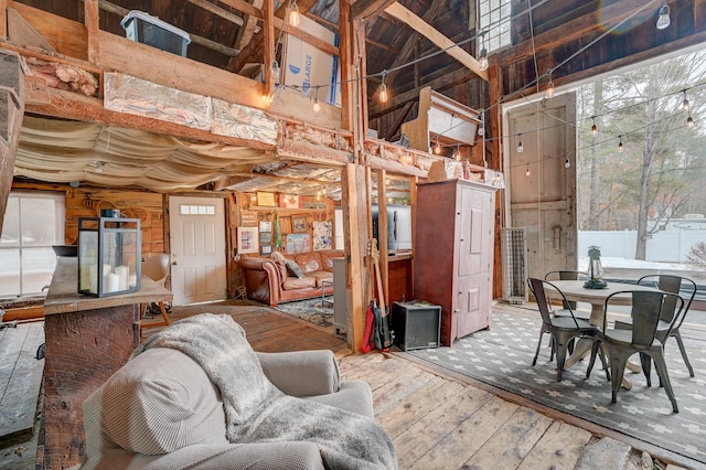 917 Main St, Fryeburg, ME 04037 - living area featuring a high ceiling, wood walls, and wood-type flooring