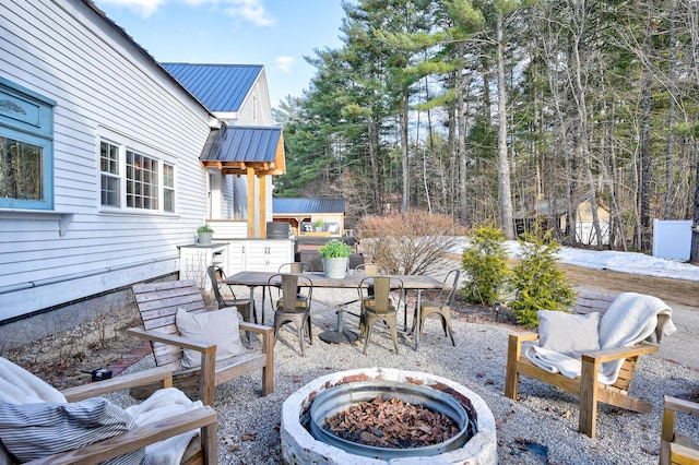 917 Main St, Fryeburg, ME 04037 - view of patio featuring an outdoor fire pit and outdoor dining space