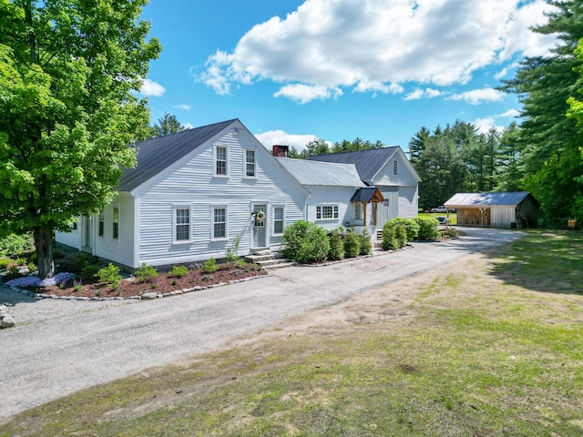 917 Main St, Fryeburg, ME 04037 - bungalow-style house with a chimney, an outbuilding, driveway, metal roof, and a front yard