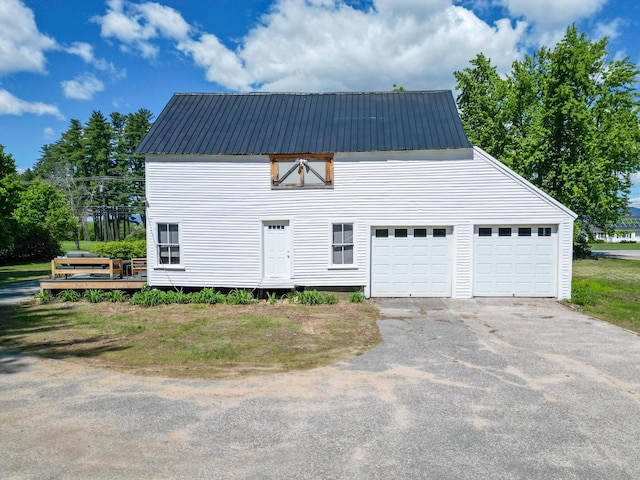 917 Main St, Fryeburg, ME 04037 - view of front facade with a garage, metal roof, and asphalt driveway