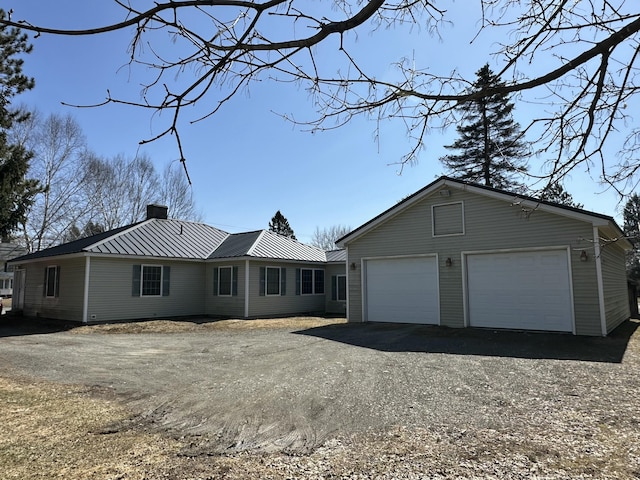 102 N St, Houlton, ME 04730 - single story home featuring an outbuilding, metal roof, a garage, and a chimney