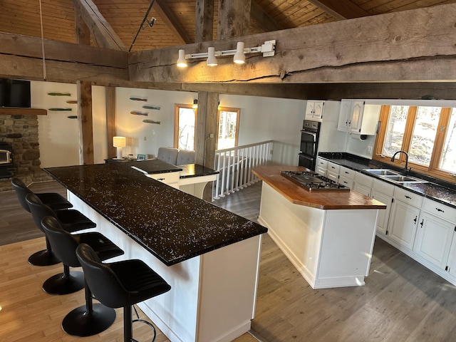 93 Goods Point Rd, Steuben, ME 04680 - kitchen featuring a sink, lofted ceiling with beams, wood finished floors, wooden ceiling, and a kitchen island
