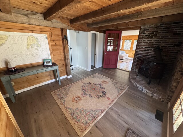 93 Goods Point Rd, Steuben, ME 04680 - foyer with a wood stove, wood ceiling, beamed ceiling, and dark wood-type flooring
