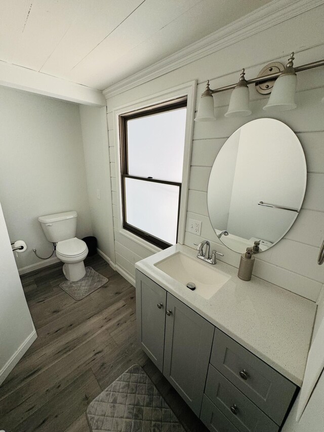 93 Goods Point Rd, Steuben, ME 04680 - bathroom with baseboards, toilet, vanity, crown molding, and wood finished floors