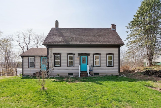 view of front of property with a front lawn, a chimney, and entry steps