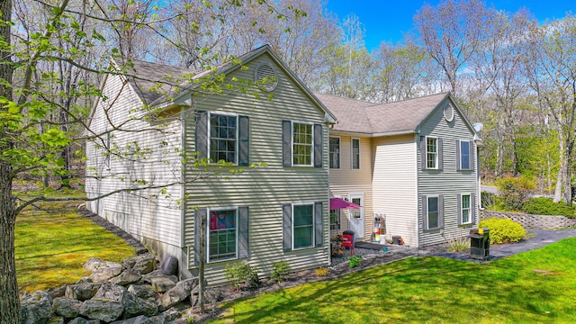 162 Roosevelt Trl Unit 3, Casco, ME 04015 - back of house featuring a lawn and a patio
