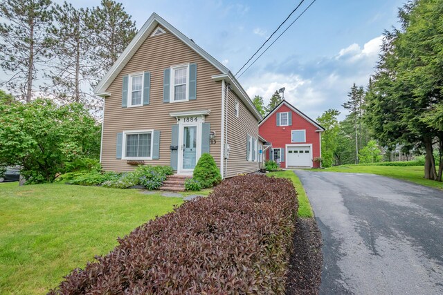 13 Park St, Dover-Foxcroft, ME 04426 - traditional-style house with a front lawn, a detached garage, and driveway