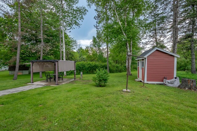 13 Park St, Dover-Foxcroft, ME 04426 - view of green lawn featuring an outbuilding and a detached carport