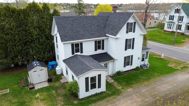 22 Bridge St, Milbridge, ME 04658 - view of front of property with roof with shingles, a storage shed, an outbuilding, and a chimney