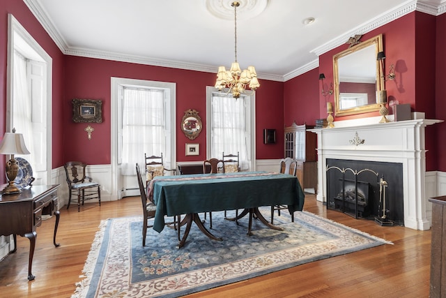 103 S St, Bath, ME 04530 - dining area with wood finished floors, a wainscoted wall, a notable chandelier, and a baseboard heating unit