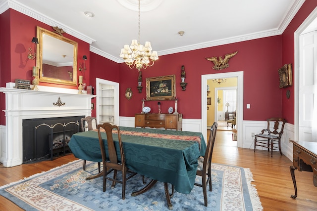103 S St, Bath, ME 04530 - dining space featuring wainscoting, wood finished floors, a notable chandelier, and crown molding