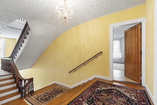 103 S St, Bath, ME 04530 - stairway featuring a textured ceiling, hardwood / wood-style floors, baseboard heating, and baseboards