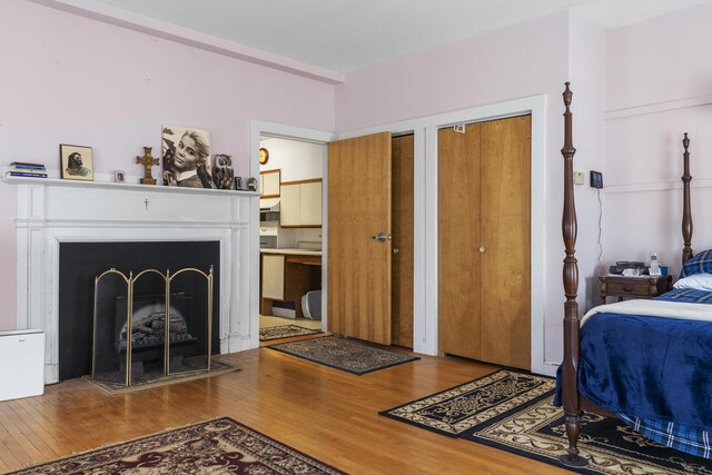 103 S St, Bath, ME 04530 - bedroom with wood finished floors, multiple closets, and a fireplace with raised hearth