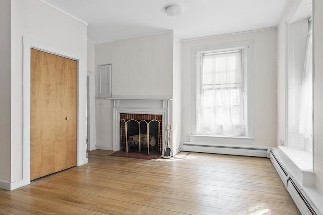 103 S St, Bath, ME 04530 - unfurnished living room featuring a baseboard heating unit, crown molding, and light wood-style floors