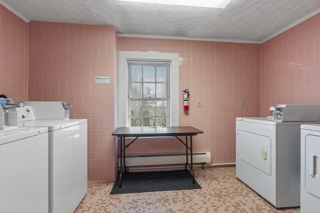 103 S St, Bath, ME 04530 - shared laundry area with a baseboard heating unit, tile walls, washing machine and clothes dryer, a textured ceiling, and light floors
