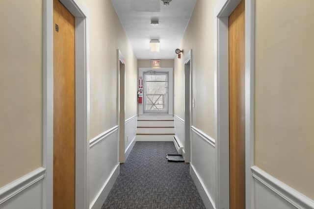 103 S St, Bath, ME 04530 - corridor featuring baseboard heating, wainscoting, and dark colored carpet