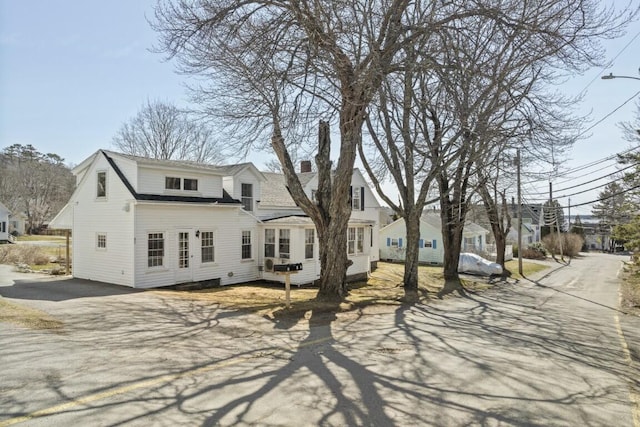 9 School St, Boothbay Harbor, ME 04538 - rear view of property with a residential view, driveway, and a chimney