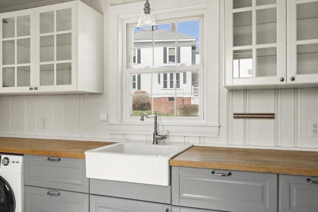 9 School St, Boothbay Harbor, ME 04538 - bar featuring washer / clothes dryer, a sink, and a healthy amount of sunlight