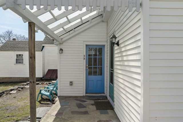 9 School St, Boothbay Harbor, ME 04538 - view of exterior entry featuring roof with shingles