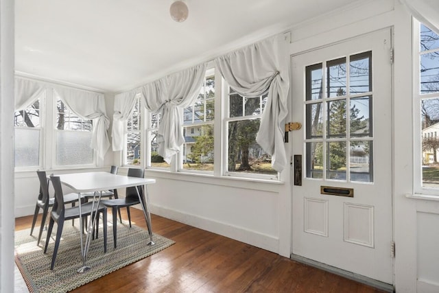 9 School St, Boothbay Harbor, ME 04538 - sunroom featuring wood finished floors, baseboards, and a healthy amount of sunlight