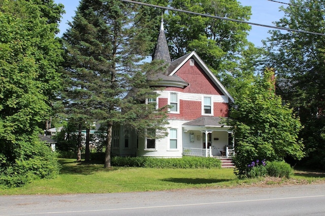 16 Pleasant St, Milo, ME 04463 - victorian home with a porch and a front lawn