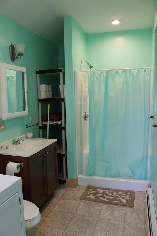 16 Pleasant St, Milo, ME 04463 - bathroom with vanity, washer / dryer, a baseboard heating unit, and a stall shower