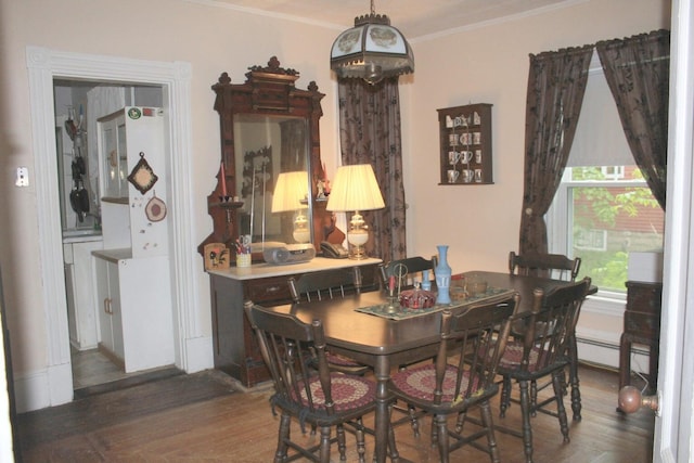 16 Pleasant St, Milo, ME 04463 - dining room with a baseboard radiator, crown molding, and wood finished floors