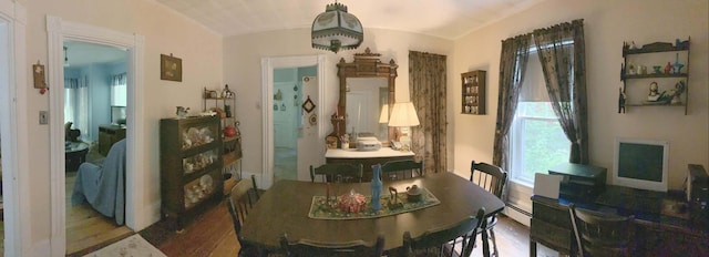 16 Pleasant St, Milo, ME 04463 - dining area featuring wood finished floors, a baseboard heating unit, and lofted ceiling