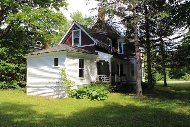 16 Pleasant St, Milo, ME 04463 - view of side of home featuring a porch, a lawn, and a chimney