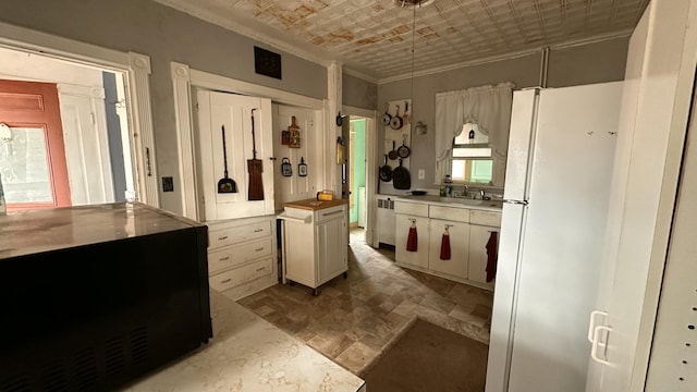 16 Pleasant St, Milo, ME 04463 - kitchen with a sink, ornamental molding, freestanding refrigerator, radiator, and an ornate ceiling
