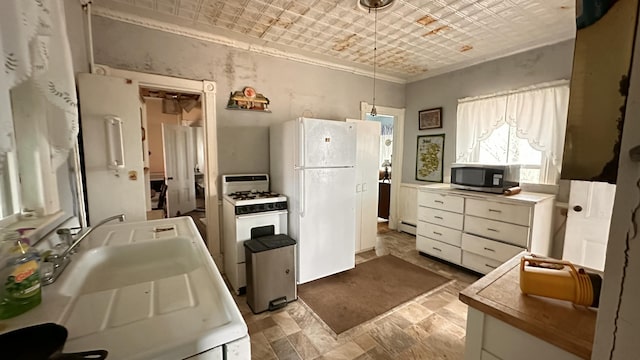 16 Pleasant St, Milo, ME 04463 - kitchen featuring white appliances, white cabinetry, crown molding, an ornate ceiling, and hanging light fixtures
