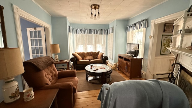 16 Pleasant St, Milo, ME 04463 - living area featuring a fireplace, wood-type flooring, and a baseboard radiator