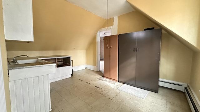 16 Pleasant St, Milo, ME 04463 - bonus room featuring baseboard heating, a sink, and vaulted ceiling